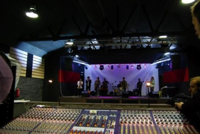 Mixing console with a band on stage