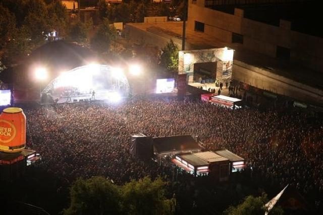 Festival crowd in front of a lit stage
